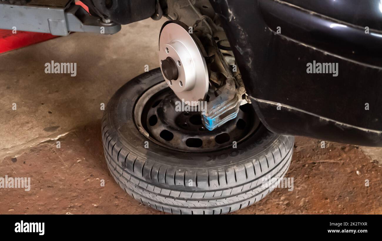 Replacing a new car brake disc Stock Photo