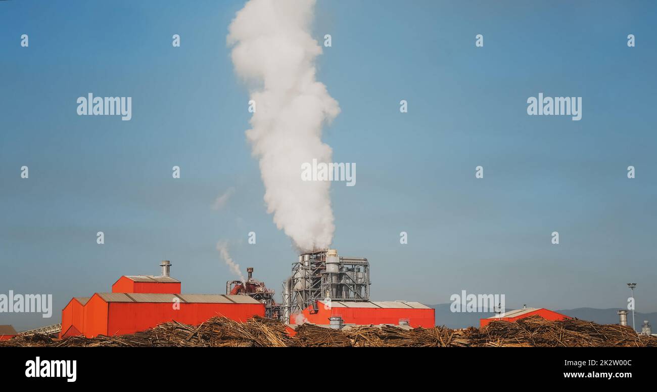 Factory pumping out smoke and steam. Stock Photo