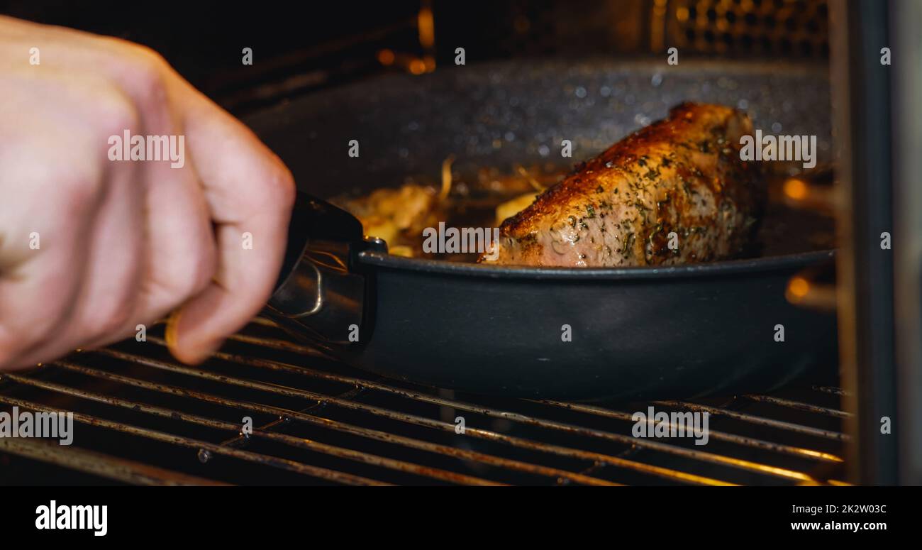 Pork Meat put in oven for cooking. Food and health concept. Close up