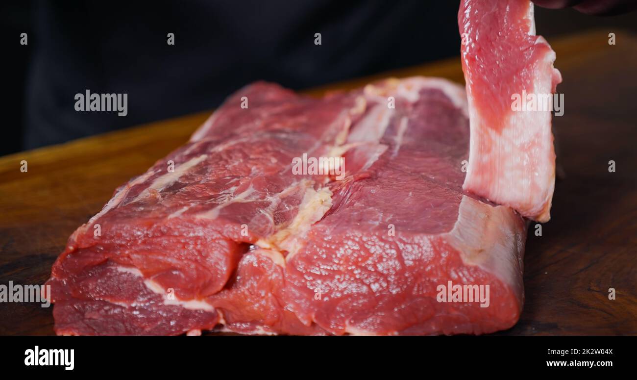 Cutting Portions of Fresh Raw Beef Meat As Preparation Before Cooking. Food Art. Stock Photo