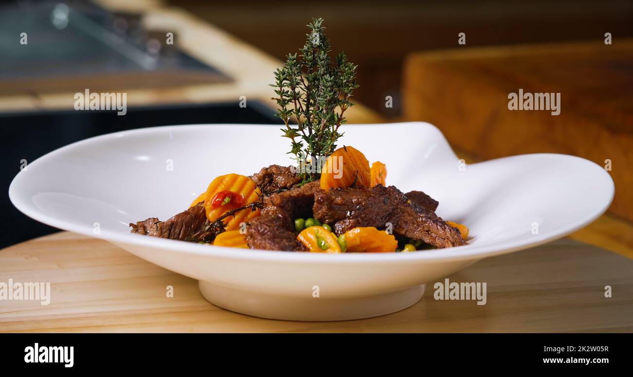 Beef Meal Presentation on White Plate. Chef Specialty Dish Stock Photo