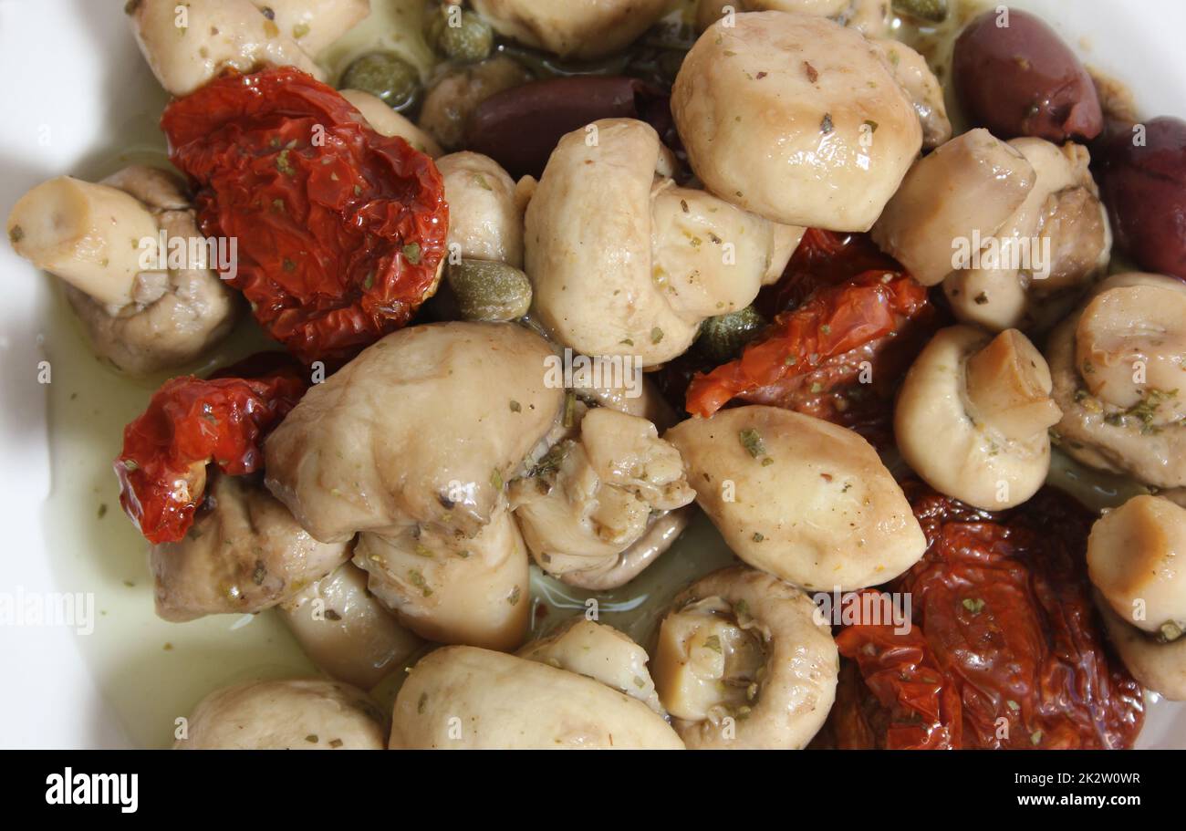 Mushrooms, Sun Dried Tomato, Olives and Capers in Olive Oil Stock Photo