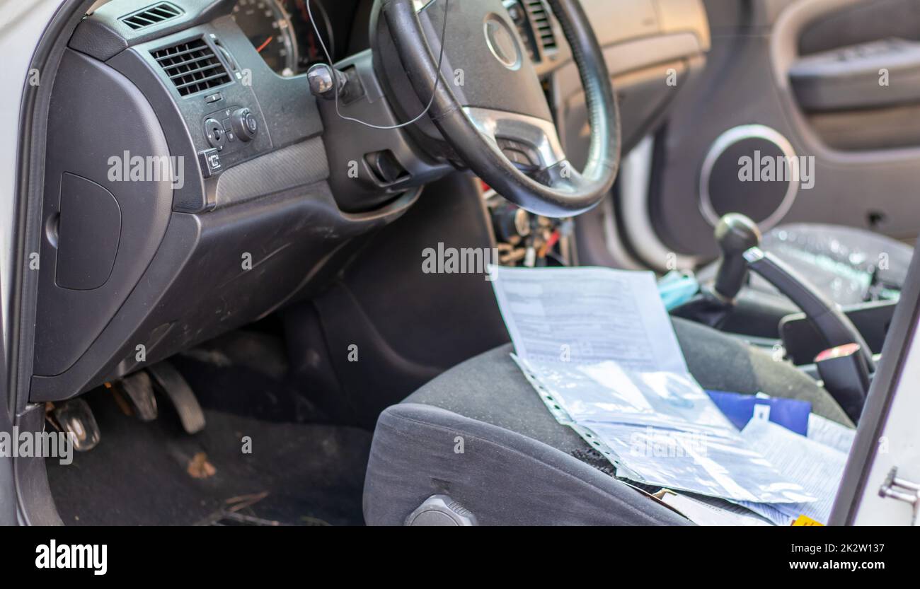 Close-up of the steering wheel of a car after an accident. The driver's airbags did not deploy. Soft focus. Broken windshield with steering wheel. Vehicle interior. Black dashboard and steering wheel. Stock Photo