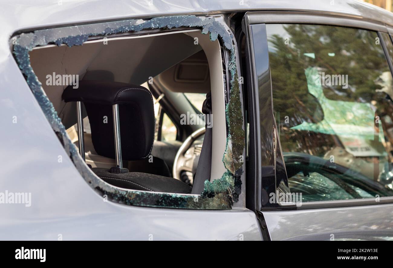 Criminal incident. Breaking into a car parked on the street. Broken