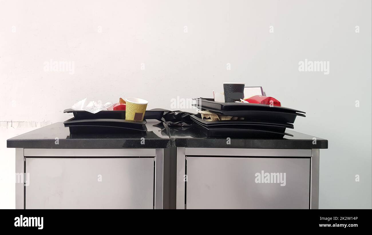 the-concept-of-cleanliness-and-cleaning-rules-at-the-exit-of-the-fast-food-trash-can-with-trays