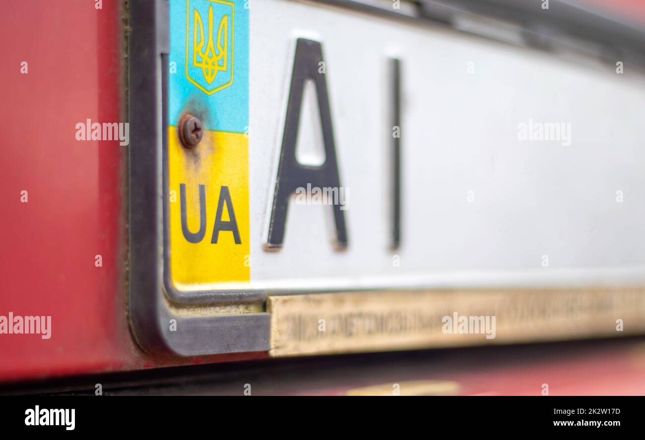 Ukrainian car registration number with national flag and coat of arms. Region code, Kyiv region AI, 10 region. Car number without numbers on the front bumper of the car, close-up. Stock Photo