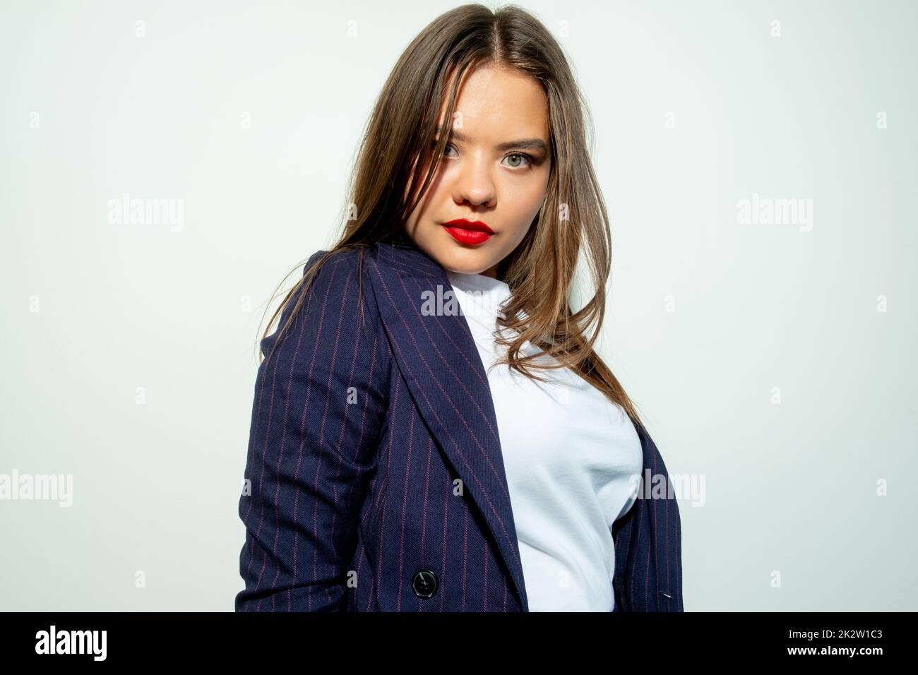 Female success. Business fashion. Leadership empowerment. Portrait of ambitious confident smart woman in blue blazer looking at camera isolated on lig Stock Photo