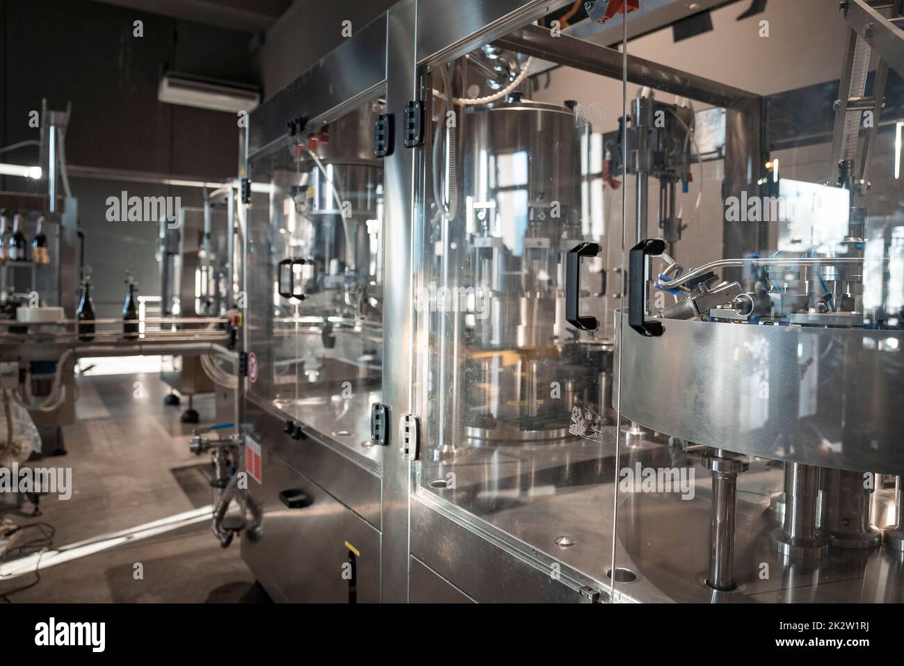 Automatic wine filling metallic machinery at wine making winery Stock Photo
