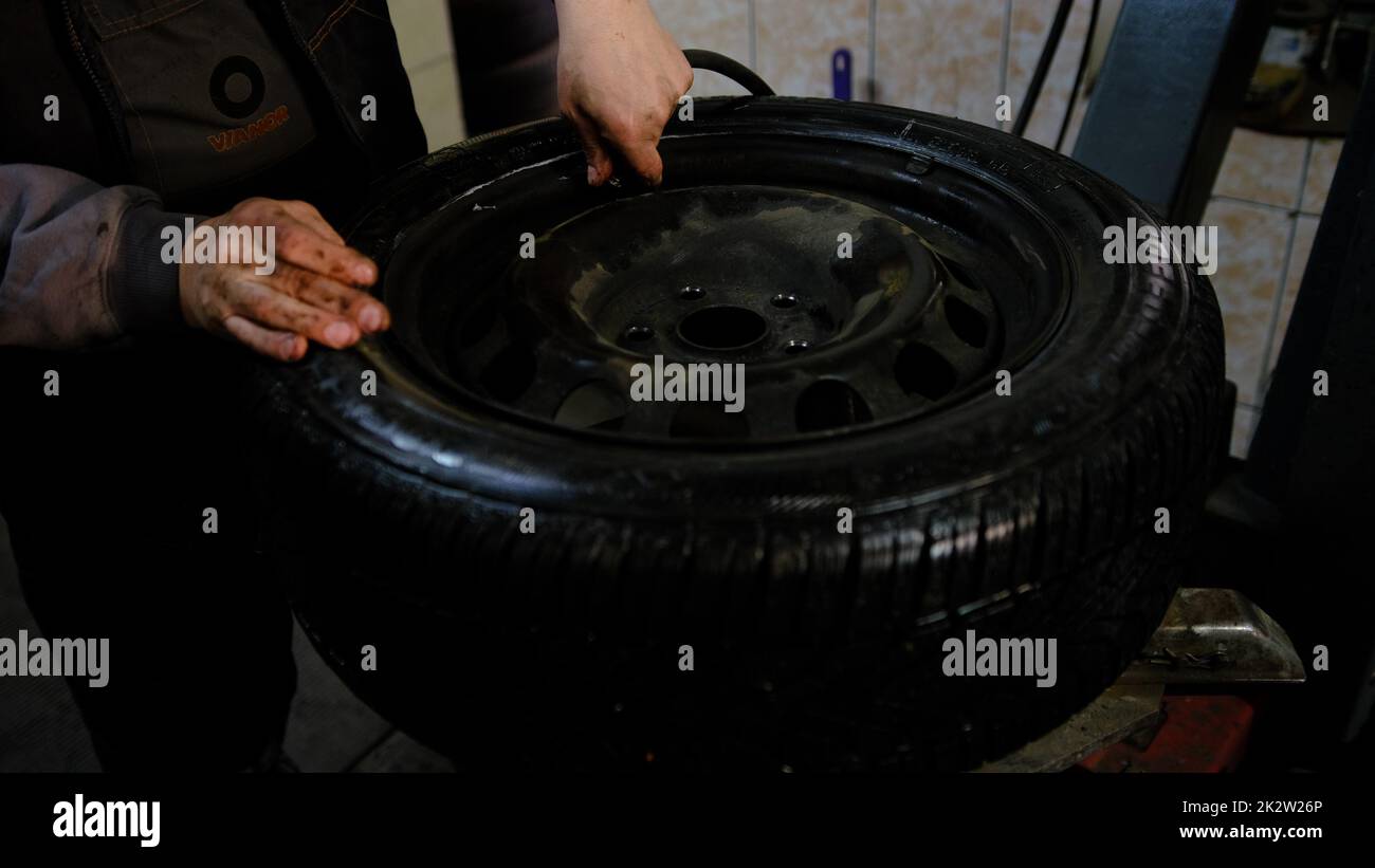 Repair service for wheel tire of car. Pump it after finish with repair Stock Photo