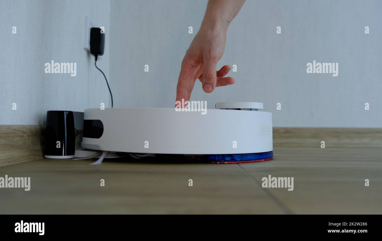 Cleaning the filter of the vacuum robot cleaner from dirt, take it out