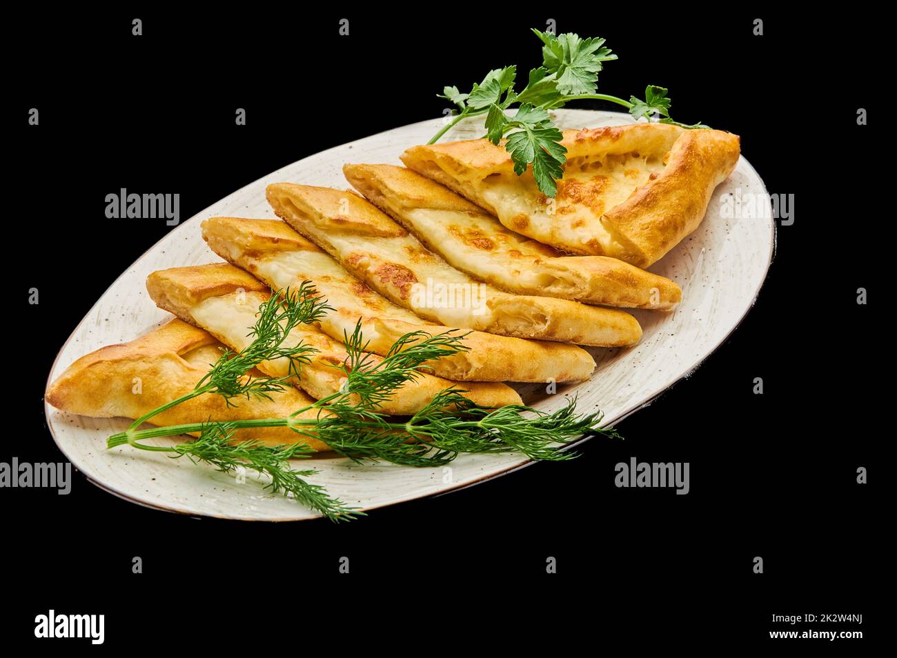 turkish pizza pide with meat on a black isolated background Stock Photo