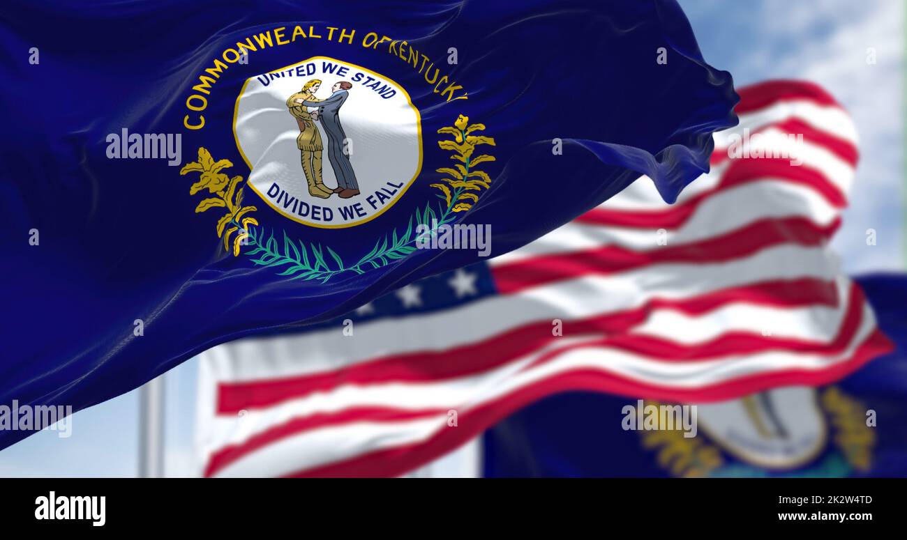 The Kentucky state flag waving along with the national flag of the United States of America Stock Photo