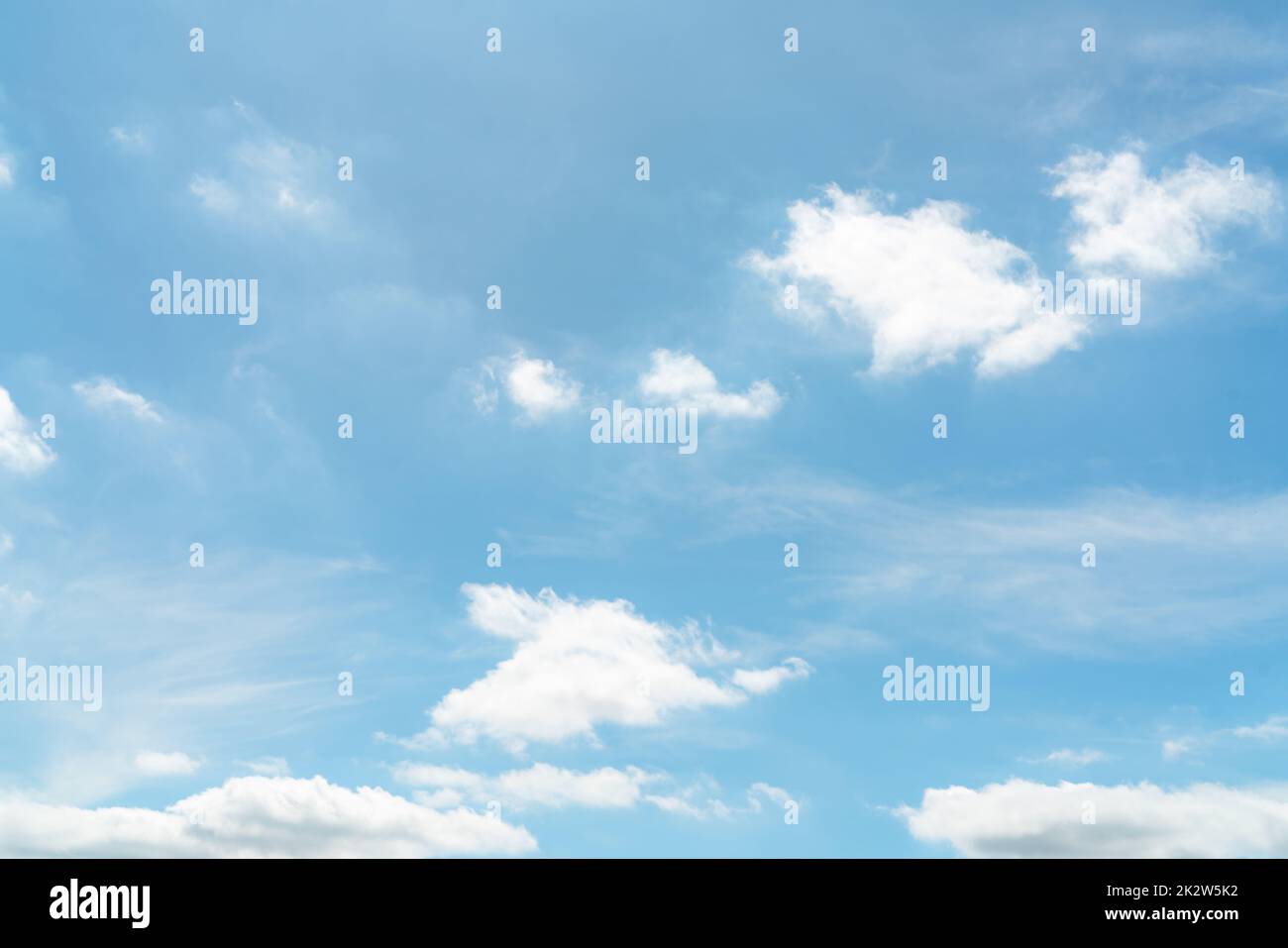 Beautiful blue sky and white cumulus clouds background. Cloudscape background. Blue sky and fluffy white clouds on sunny day. Nature weather. Panorama view of blue sky. Summer sky background. Stock Photo