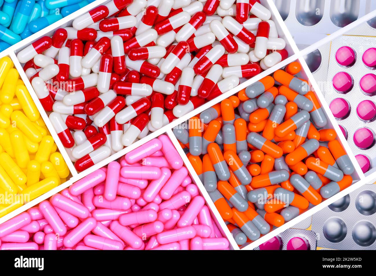 Top view of antibiotic capsules and tablet pills. Antibiotic drug resistance. Superbug. Full frame of multi-colored pills. Pharmaceutical industry. Prescription drugs. Healthcare and medicine. Stock Photo