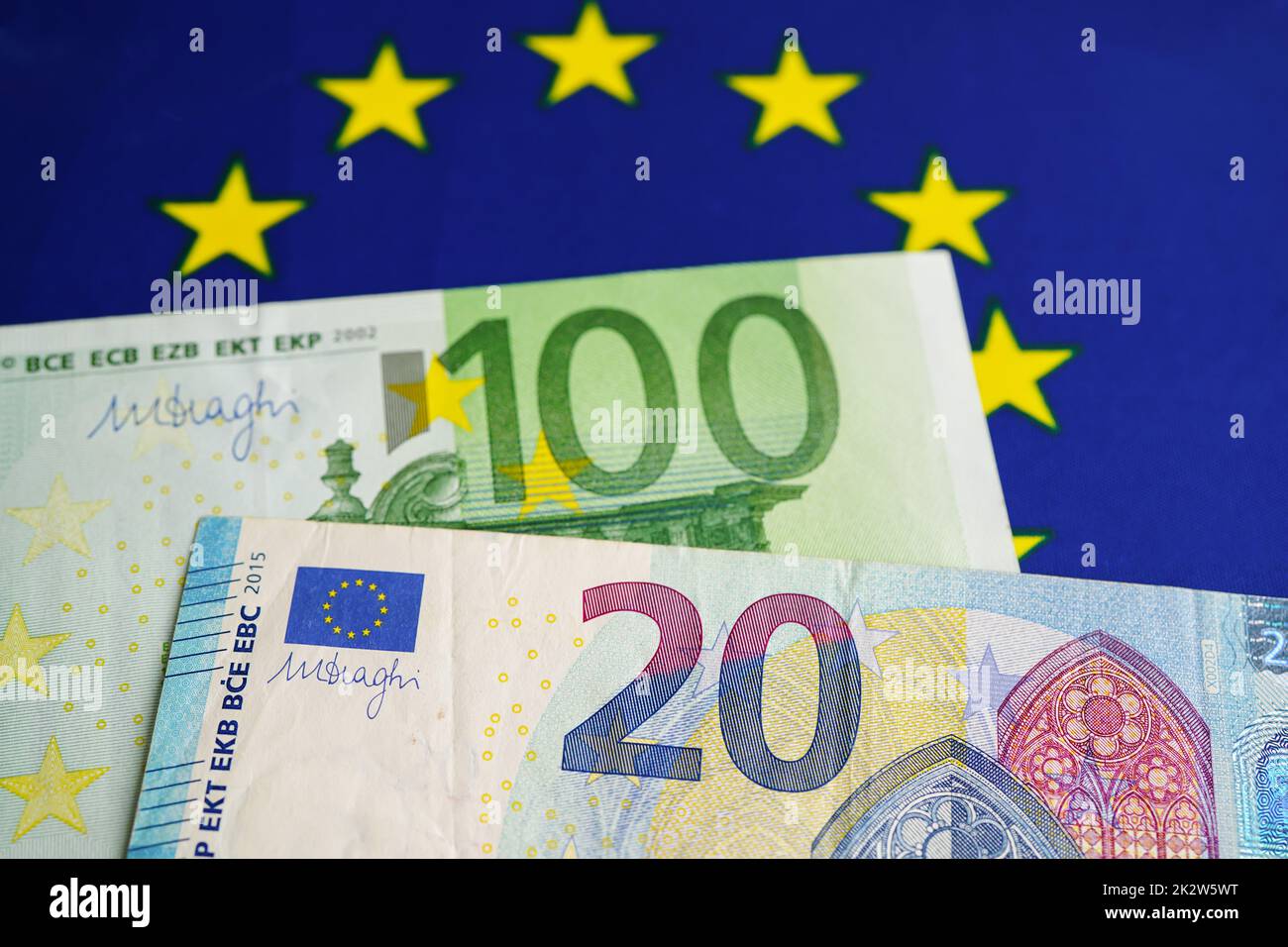 Euro banknotes money on EU flag, economy trade in europe concept. Stock Photo