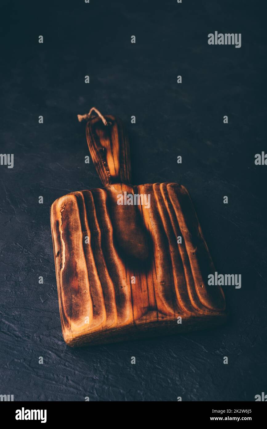 Cutting Board with Handle on Concrete Surface Stock Photo