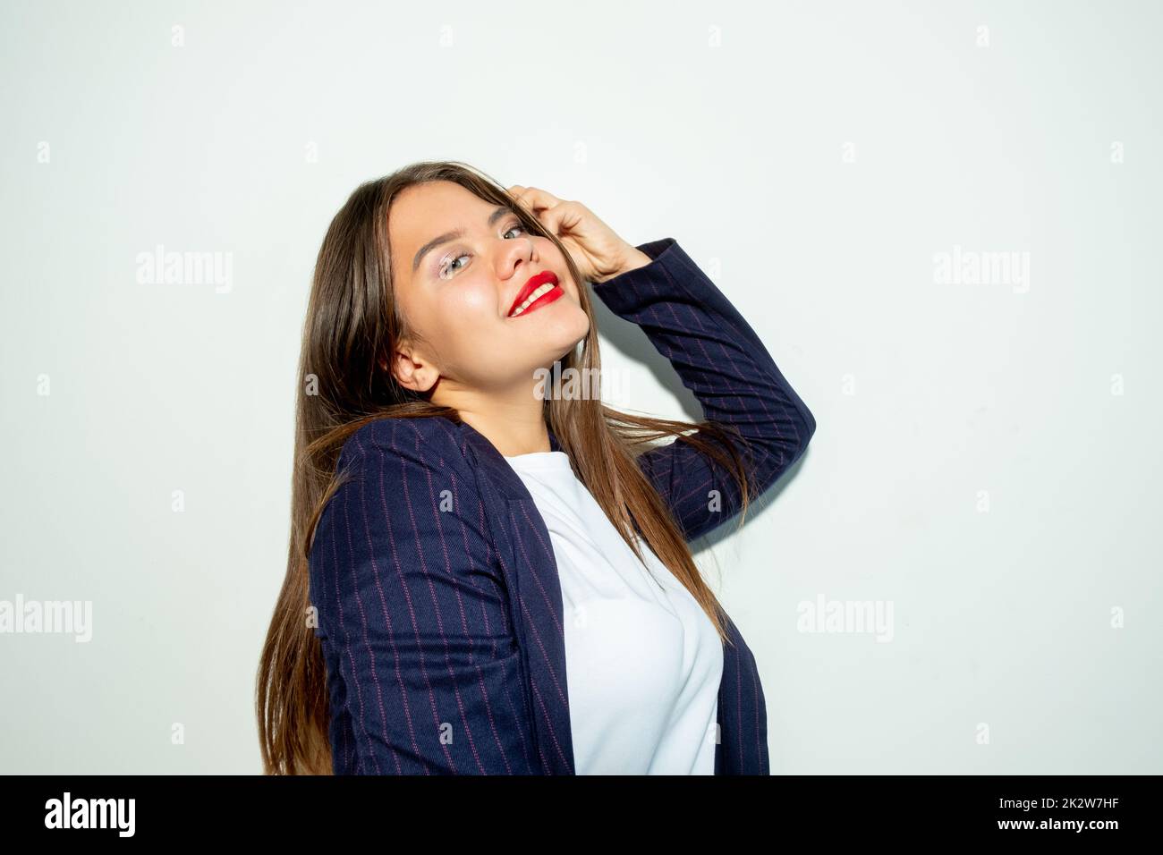 Happy business woman. Carefree lifestyle. Individuality confidence. Portrait of cheerful lady posing looking at camera smiling isolated on light neutr Stock Photo