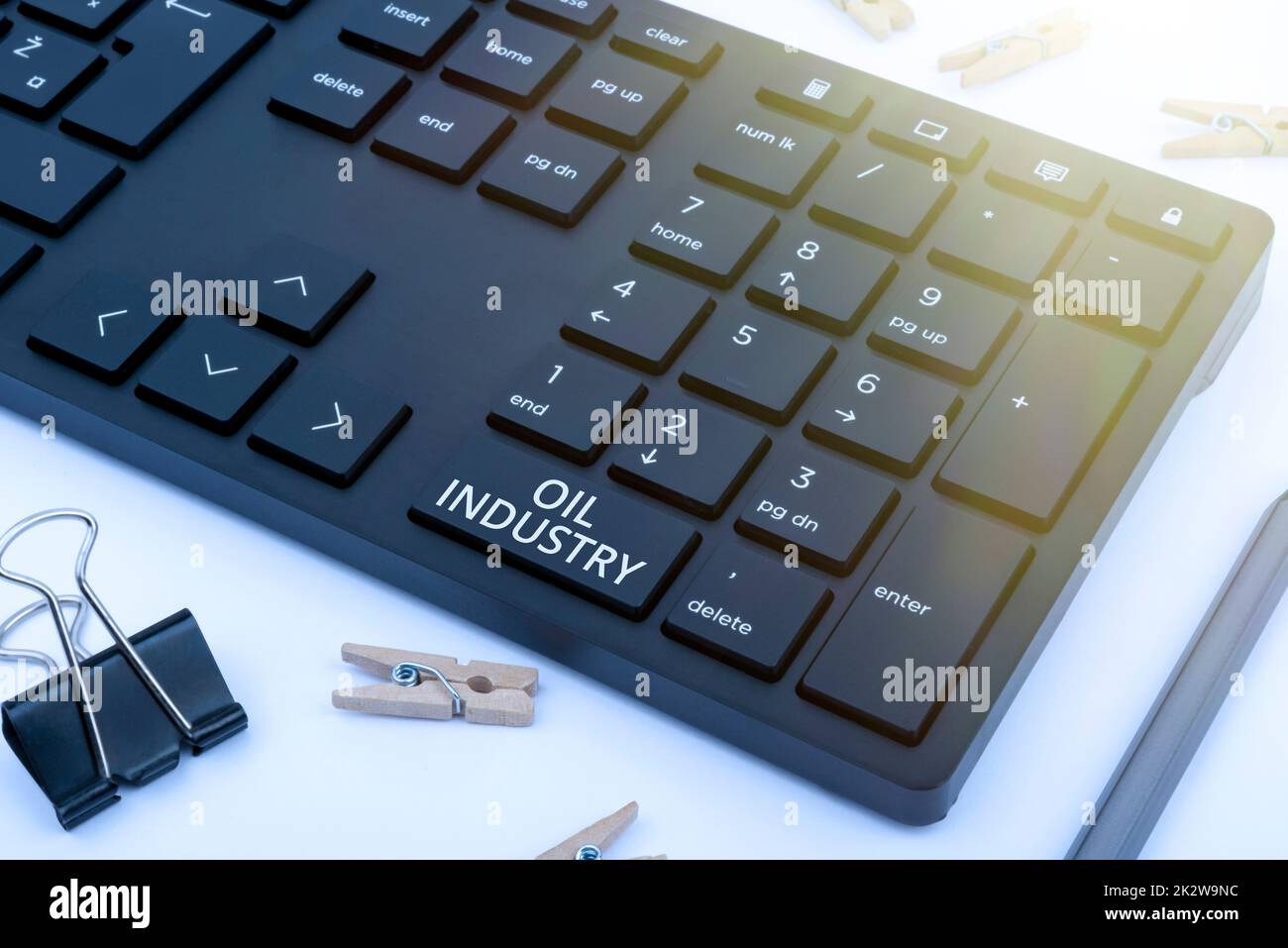 Hand writing sign Oil Industry. Business idea Exploration Extraction Refining Marketing petroleum products Computer Keyboard And Symbol.Information Medium For Communication. Stock Photo