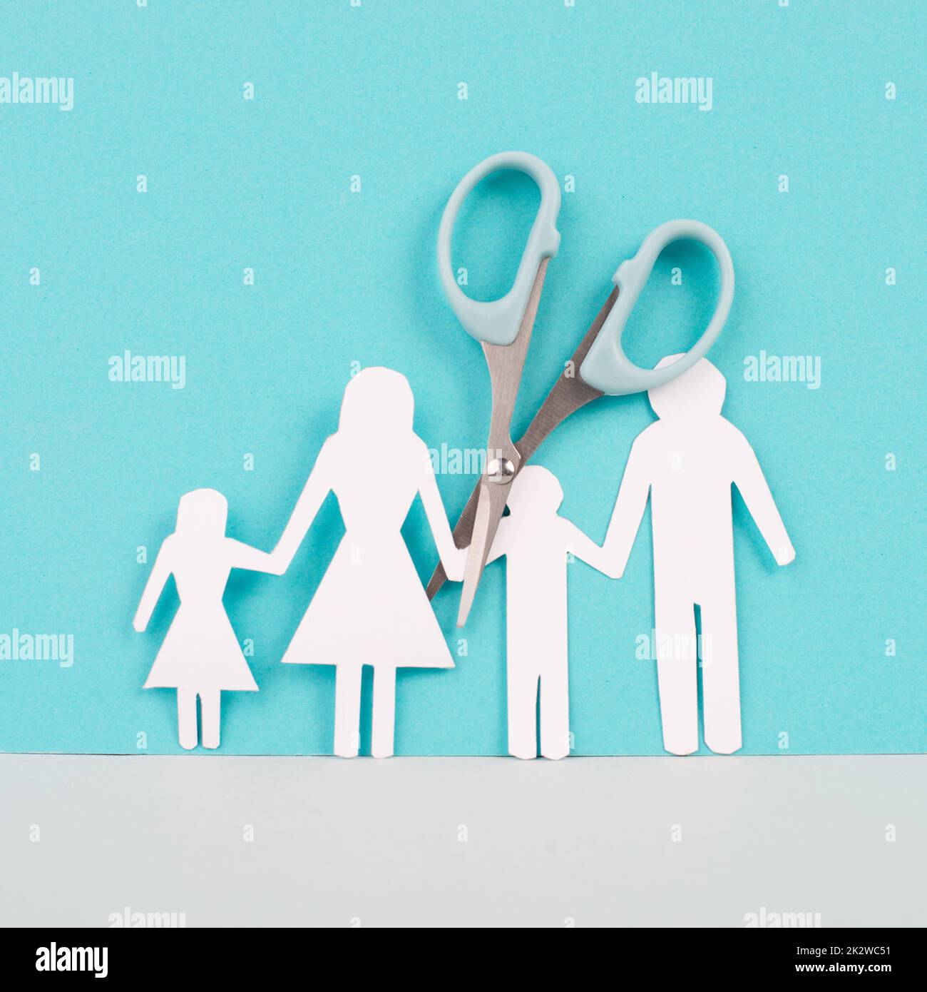 Divored parents, custody battle for the children, scissors cut the family, paper cut out, conflict in relationship, broken marriage concept Stock Photo