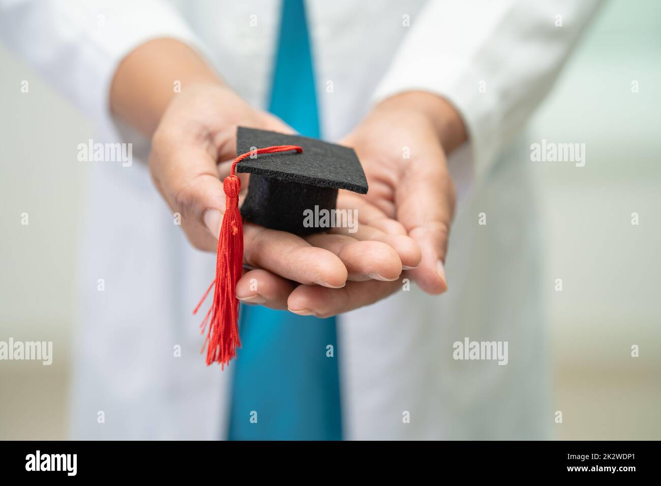 Asian doctor study learn with graduation gap hat in hospital ward, clever bright genius education medicine concept. Stock Photo