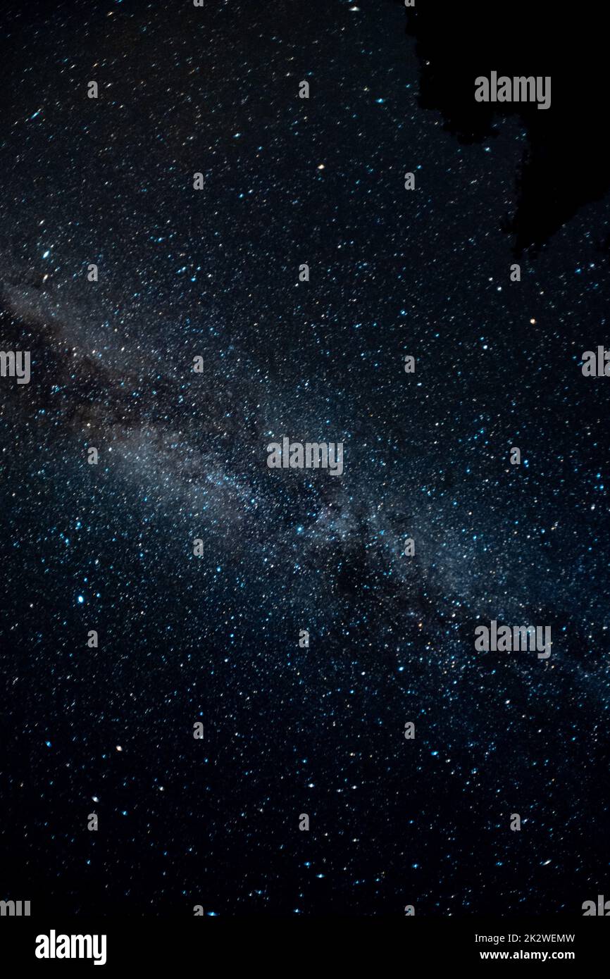 A vertical shot of Milky Way illuminating a dark night sky Stock Photo ...