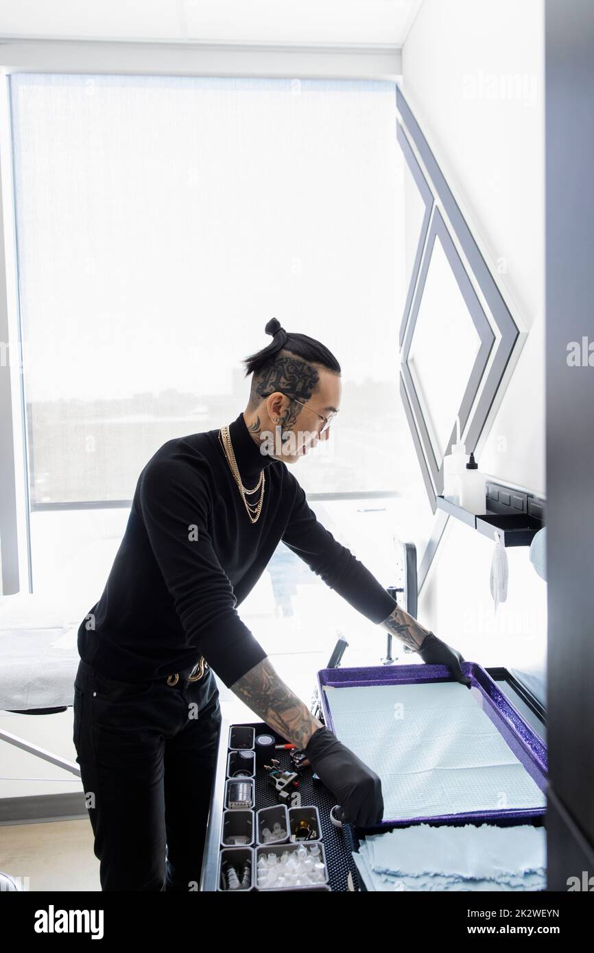 Tattoo artist preparing equipment in studio Stock Photo Alamy