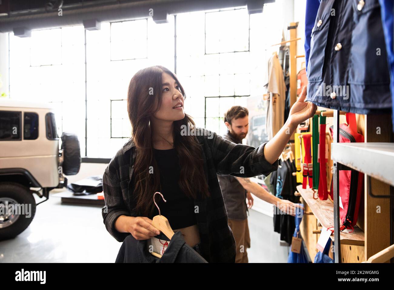 Woman shopping for outerwear in sporting goods store Stock Photo
