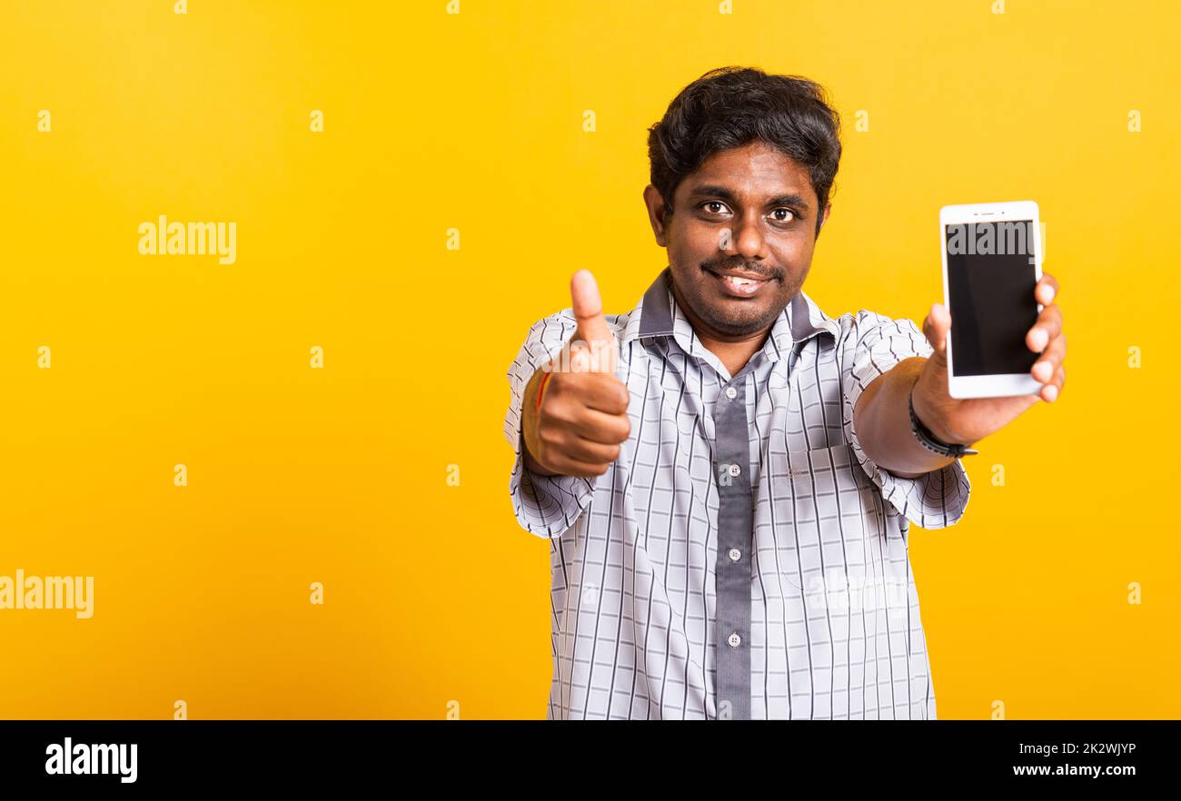 black man smile showing a mobile smartphone blank screen and finger thumb up Stock Photo