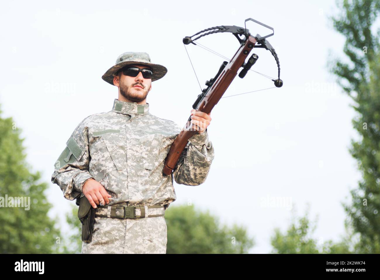 military person holding crossbow weapon Stock Photo Alamy