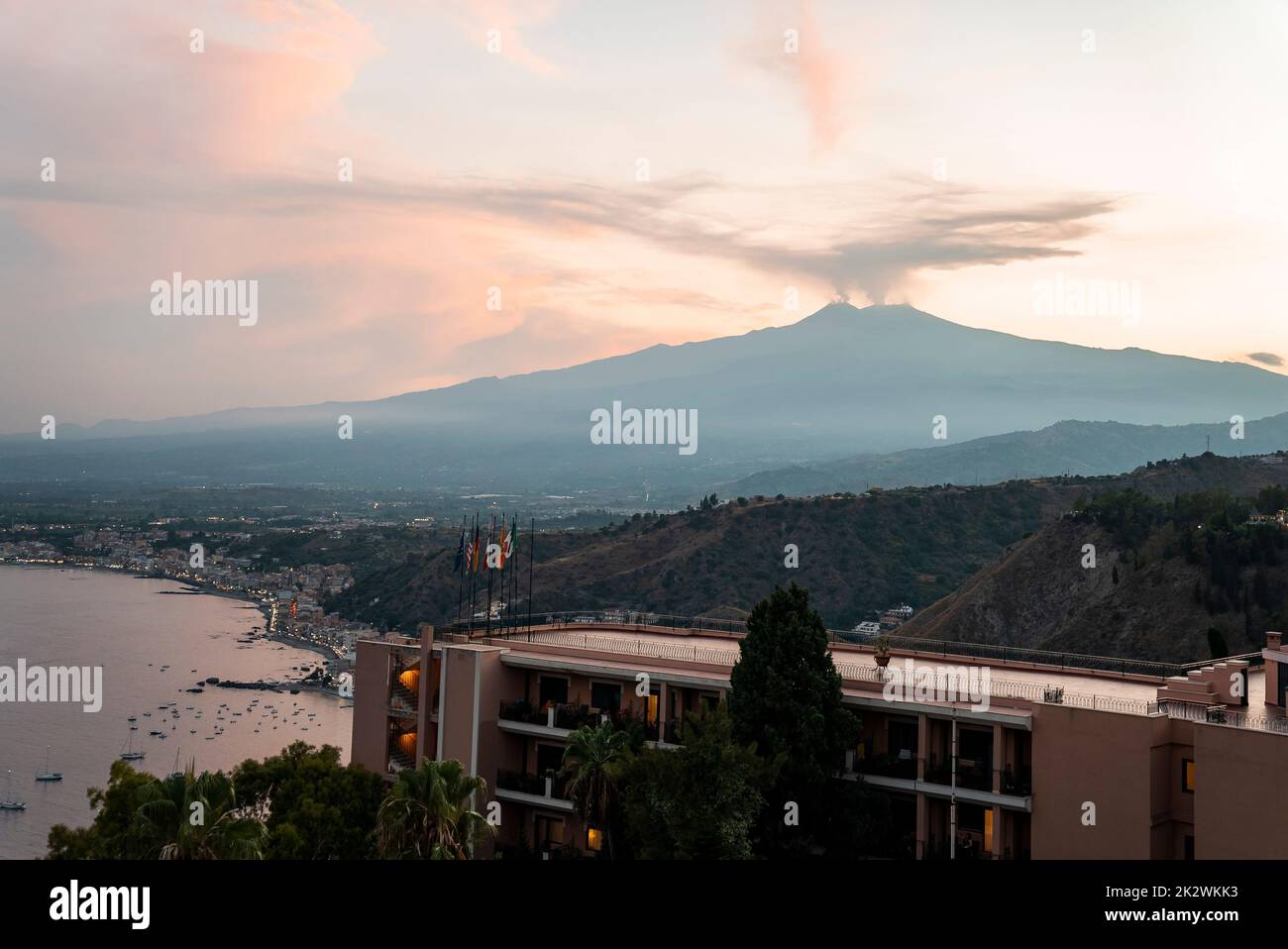 View of Hotel Elios overlooking volcanic Mount Etna with sky in background Stock Photo