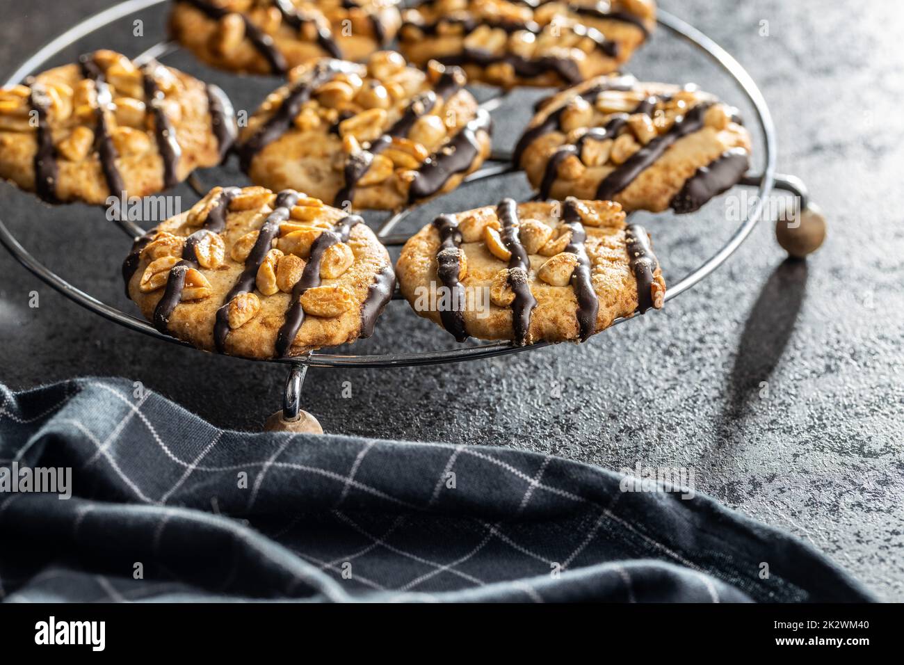 Chip cookies with peanuts and chocolate strips on black table. Stock Photo