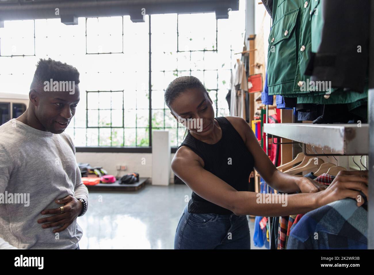 Couple shopping for outerwear in sporting goods store Stock Photo