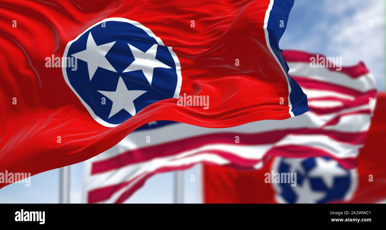 The Tennessee state flag waving along with the national flag of the United States of America Stock Photo