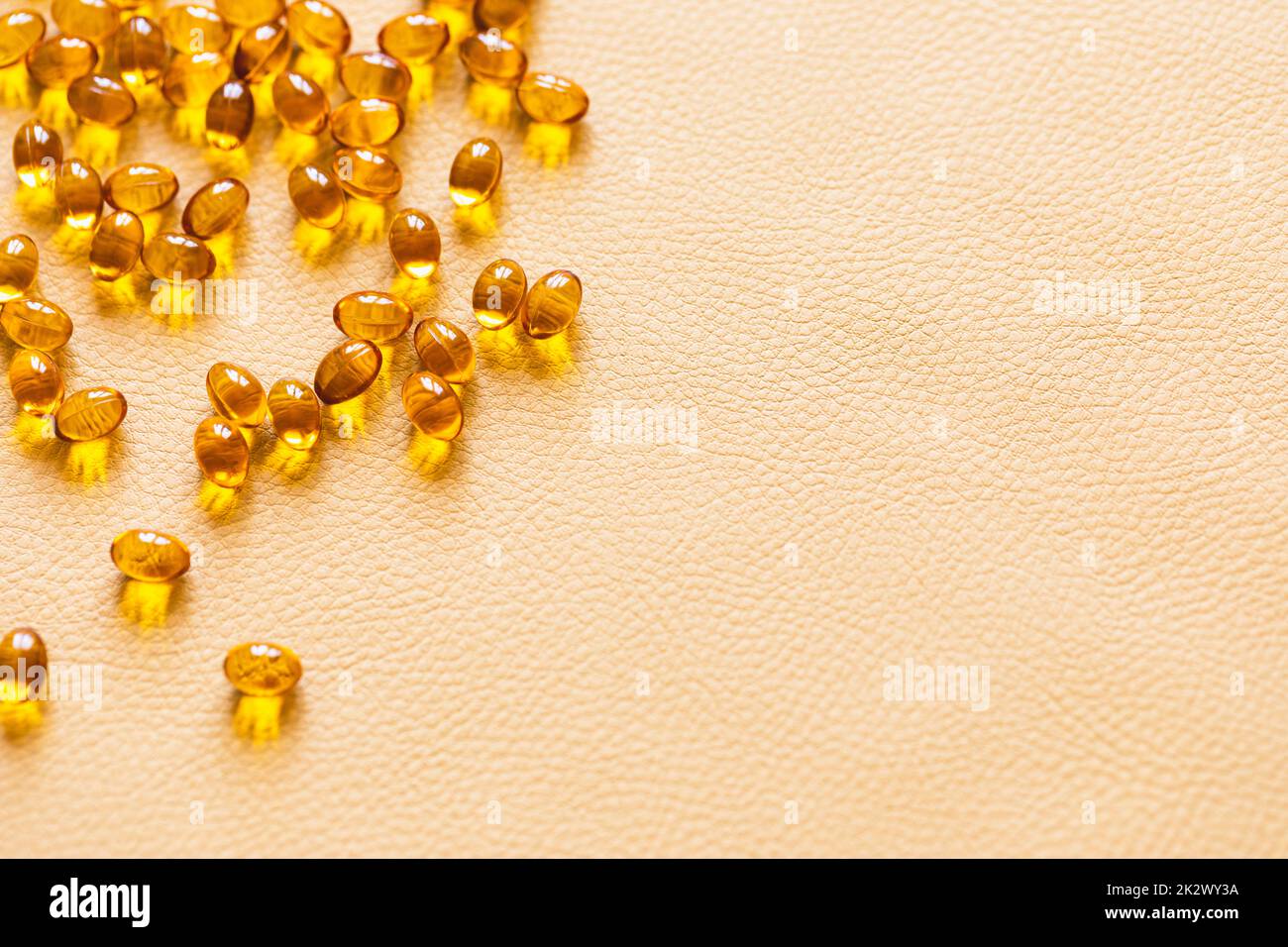 Vitamin D3 capsules. Medicine vitamins and dietary supplements. Selective focus. Close up of oil filled capsules suitable for: fish oil, omega 3, omega 6, omega 9, vitamin A, vitamin D, vitamin D3, vitamin E Stock Photo