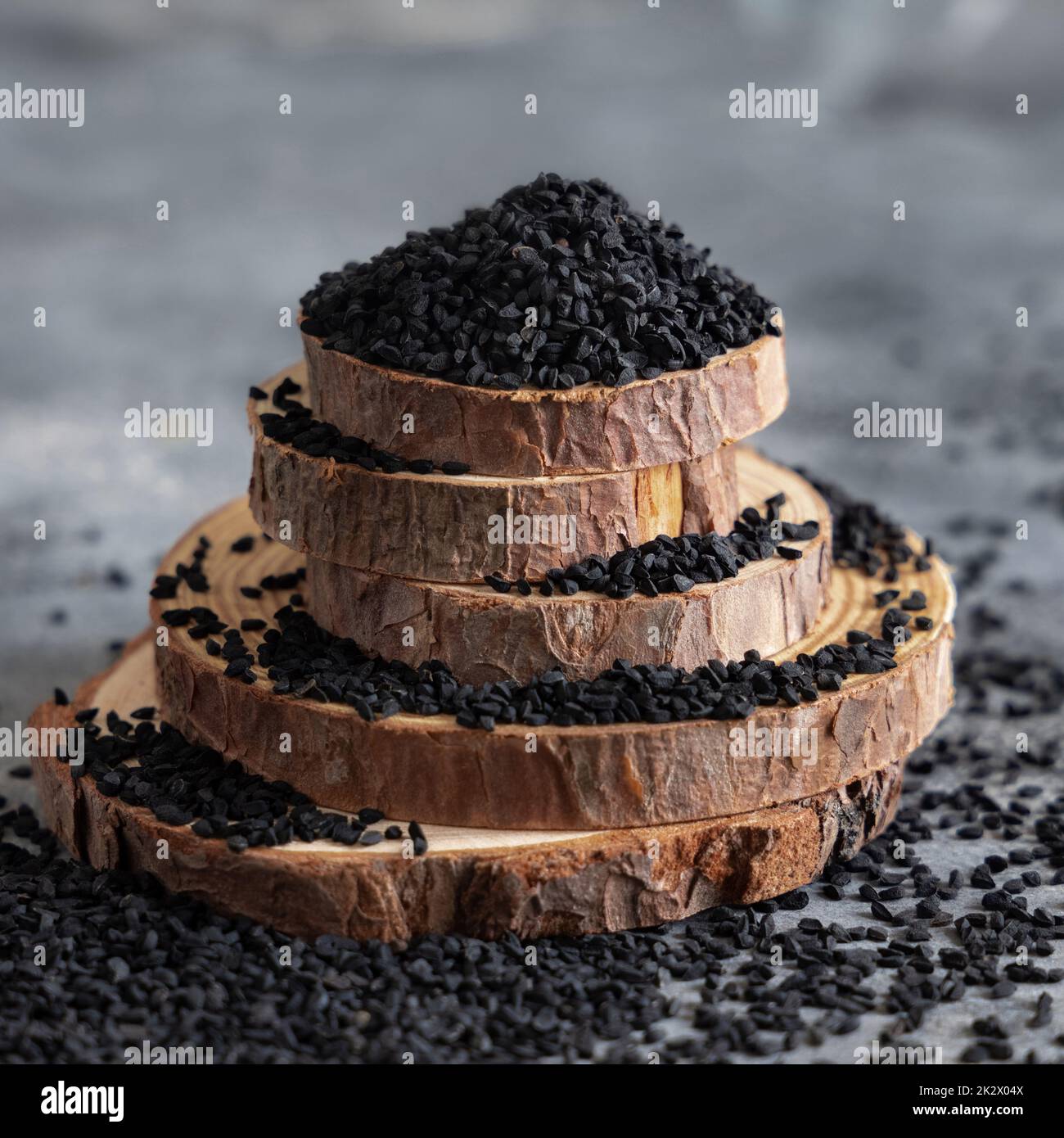 Indian spice Black cumin (nigella sativa or kalonji) seeds close up with a wooden spoon Stock Photo