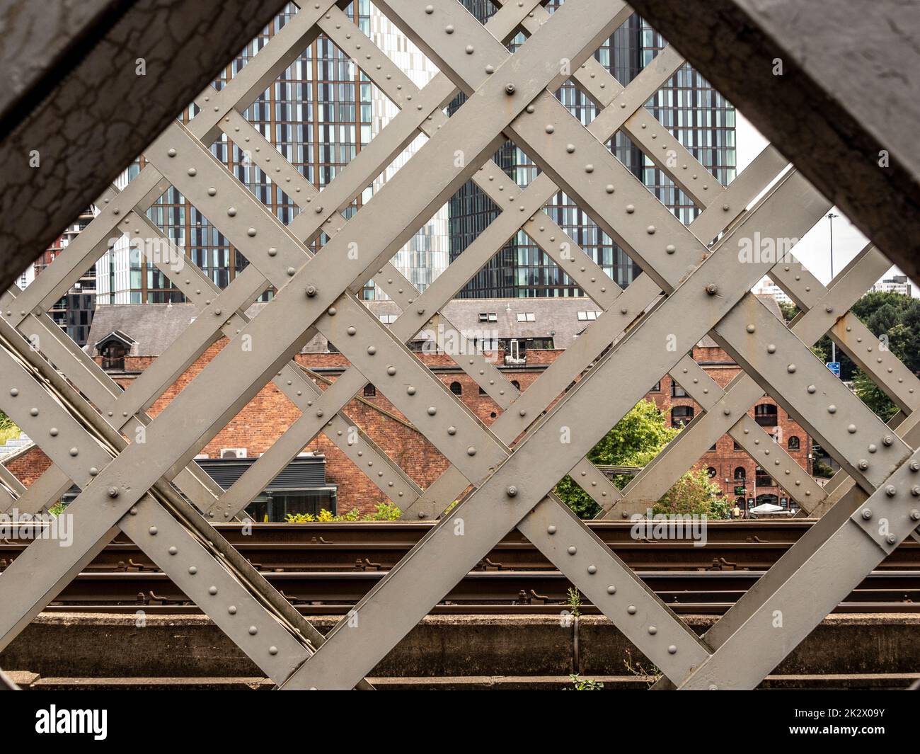 The contemporary glazed towers of Deansgate Square seen through the Victorian Castlefield viaduct. Manchester. UK Stock Photo