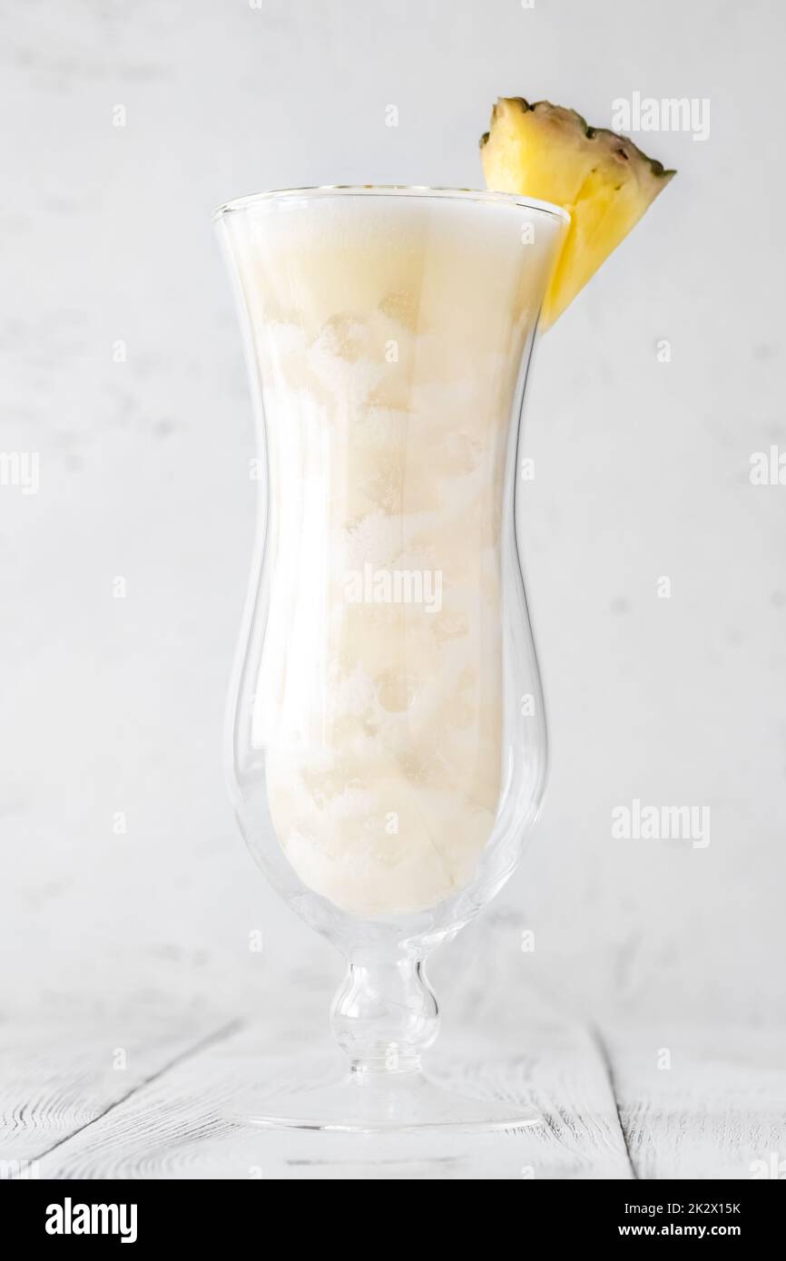 Glass of pina colada cocktail garnished with pineapple wedge Stock Photo
