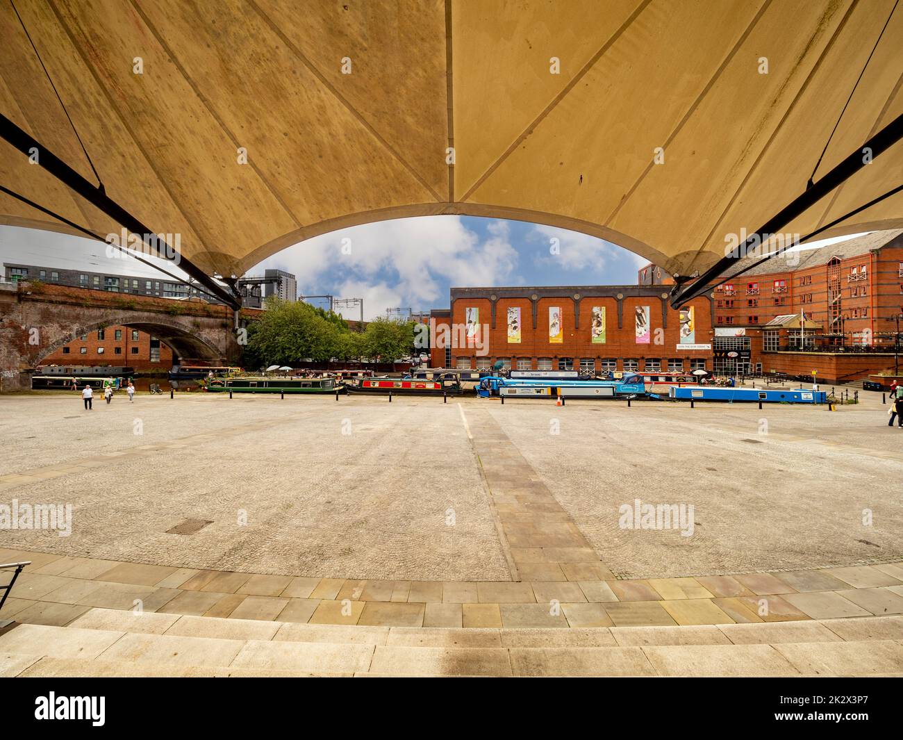 Castlefield bowl, a covered outdoor amphitheatre style venue with moored narrowboats and Y Club in the distance. Manchester. UK. Stock Photo