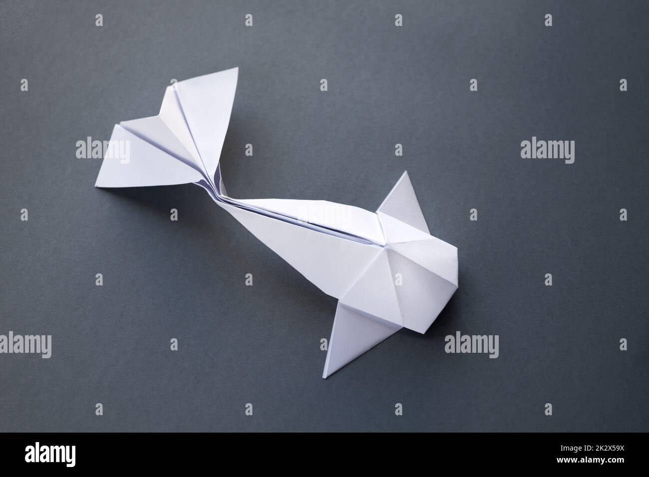 White paper fish origami isolated on a grey background Stock Photo