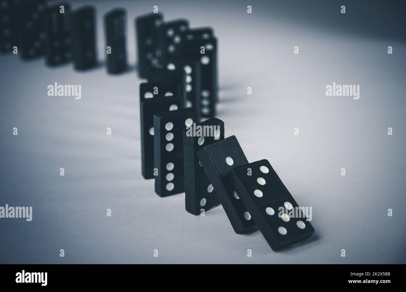 Black dominoes chain on table background Stock Photo