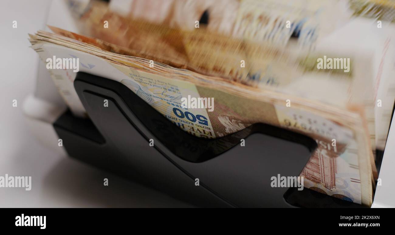 Electronic money counter machine count Hong Kong banknote Stock Photo