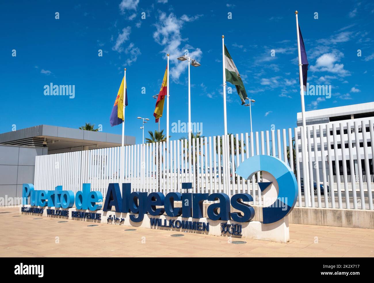 The welcome to Puerto de Algeciras (Port of Algeciras) logo sign with flag poles behind, which is situated near the main foot passenger entrance. Stock Photo