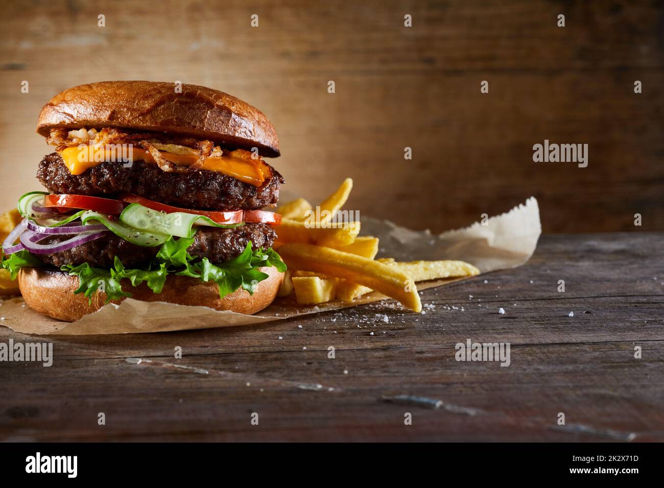 Burger with vegetables served with fries Stock Photo