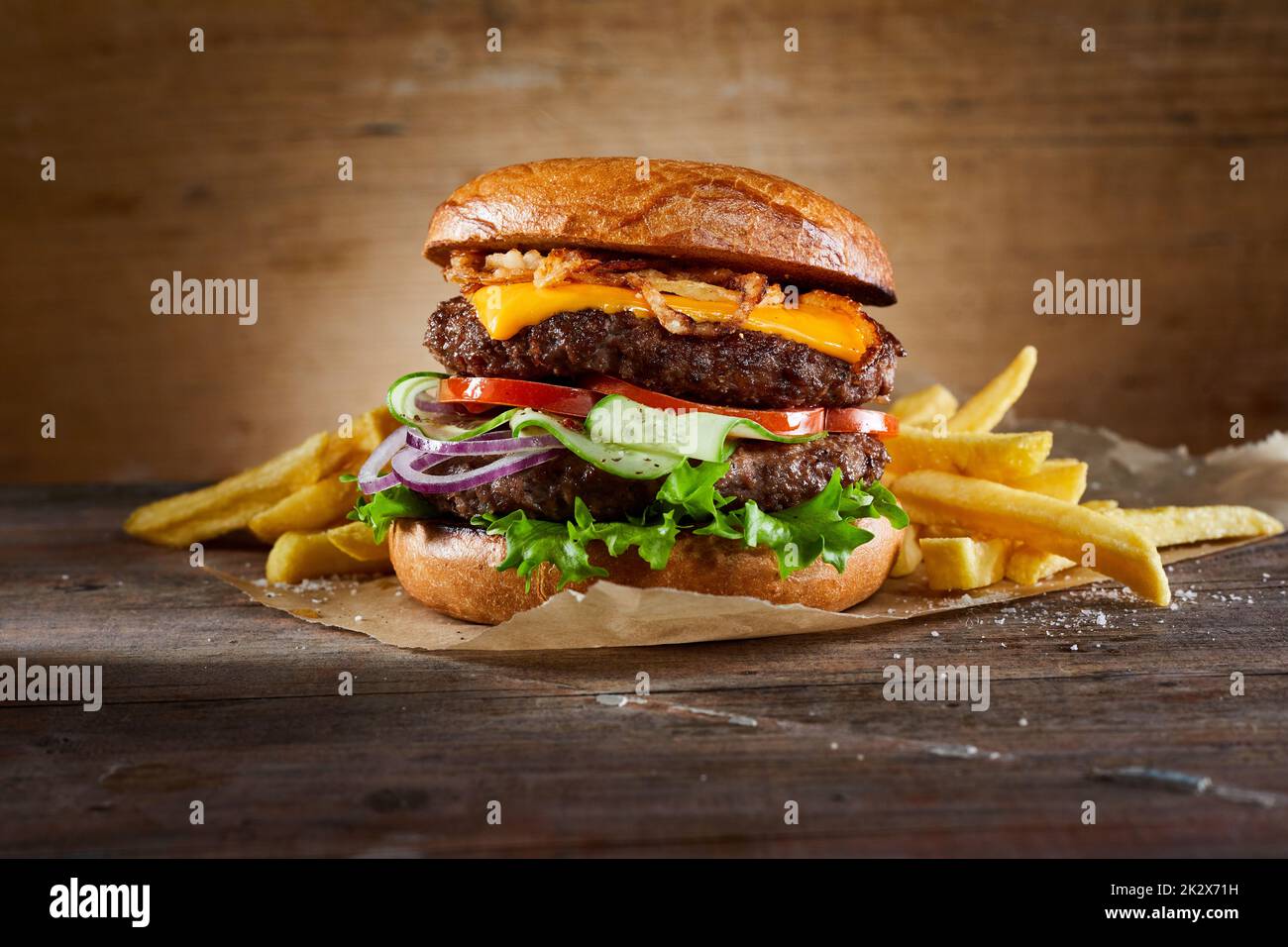 Double burger with fries on table Stock Photo