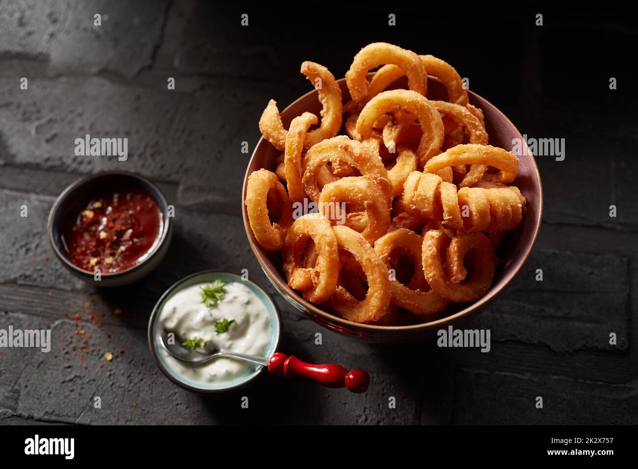 Onion rings and curly fries Stock Photo Alamy