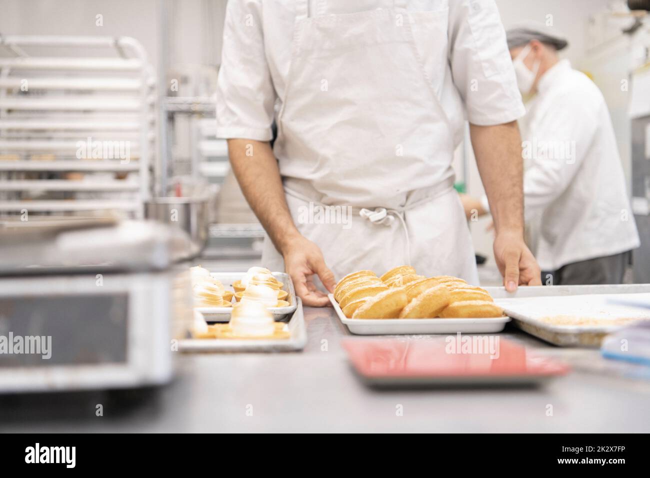 Baker preparing French pastries in bakery kitchen Stock Photo Alamy