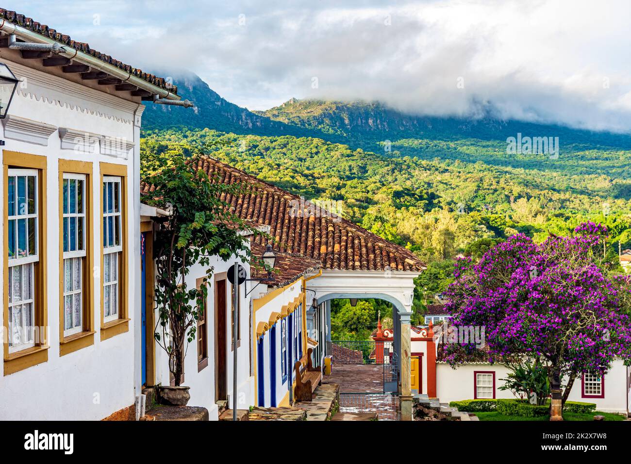 Historic colonial houses with the mountain and forest vegetation in Tiradentes city Stock Photo