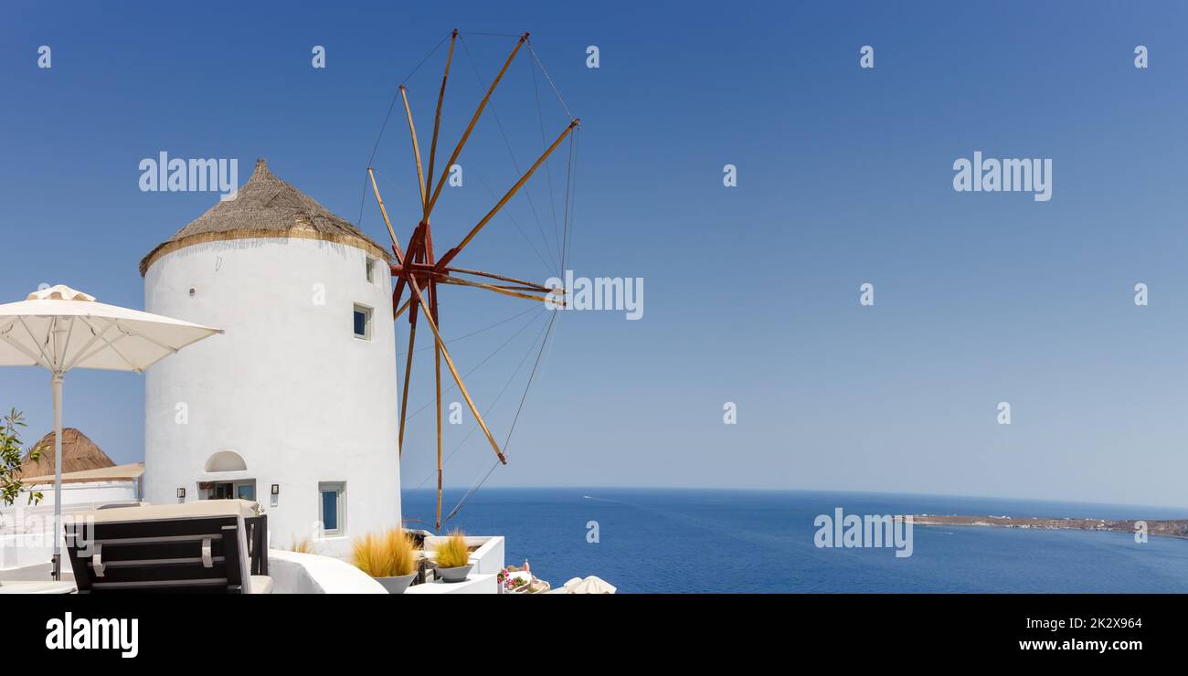 Windmill on Santorini island holidays in Greece travel traveling Oia town Mediterranean Sea Santorin panorama mill Stock Photo