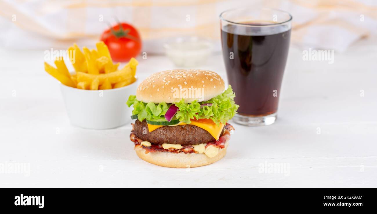 Hamburger Cheeseburger meal fastfood fast food with cola drink and French Fries on a wooden board panorama Stock Photo