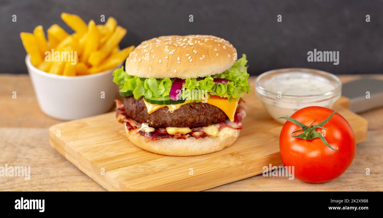 Hamburger Cheeseburger fastfood fast food with French Fries on a wooden board panorama burger Stock Photo